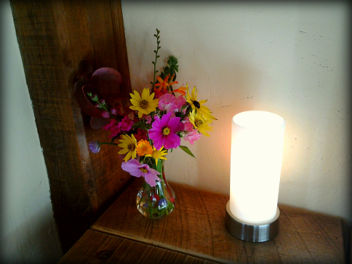 bedroom detail - lamp and vase of fresh flowers
