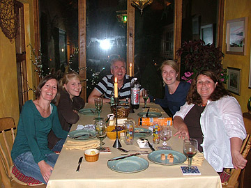 Guests with Shoron, enjoying a meal together at the cottage
